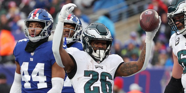 Miles Sanders #26 of the Philadelphia Eagles celebrates after a touchdown during the first quarter of a game against the New York Giants at MetLife Stadium on December 11, 2022 in East Rutherford, New Jersey.