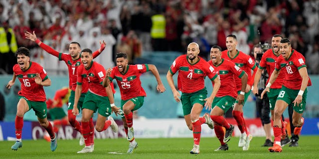 Morocco's players celebrate after the penalty shootout during their World Cup match against Spain, at the Education City Stadium in Al Rayyan, Qatar, on Dec. 6, 2022.