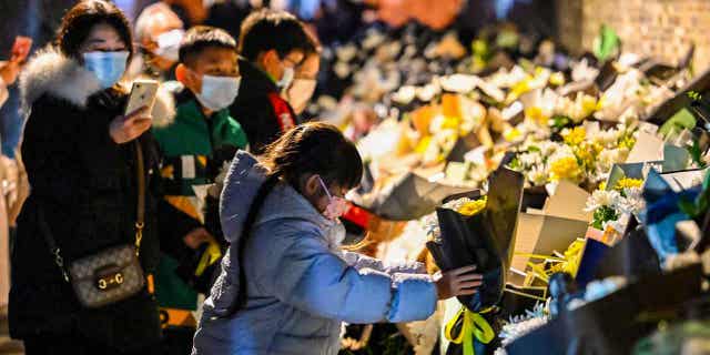Mourners place flowers outside the old home of former Chinese leader Jiang Zemin. Zemin passed away on November 30, in Yangzhou, in China's eastern Jiangsu province, on Dec. 5, 2022.