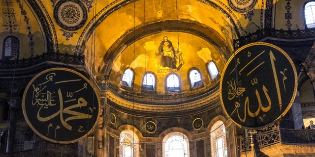 An image in Hagia Sophia shows a mural of Mary holding Jesus Christ alongside inscriptions of Allah and Muhammad.