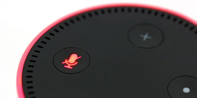 An Amazon Echo Dot with a red ring and Alexa muted