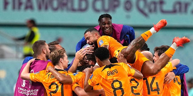 Players of the Netherlands celebrate their side's second goal by Daley Blind during the World Cup round of 16 soccer match between the Netherlands and the United States, at the Khalifa International Stadium in Doha, Qatar, Saturday, Dec. 3, 2022. 