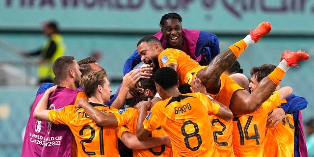 Players of the Netherlands celebrate their side's second goal by Daley Blind during the World Cup round of 16 soccer match between the Netherlands and the United States, at the Khalifa International Stadium in Doha, Qatar, Saturday, Dec. 3, 2022. 