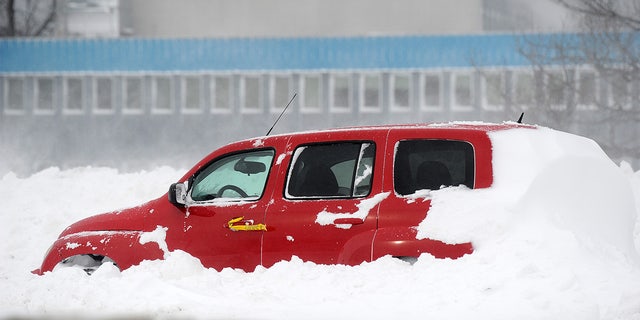  Ice and snow cover an abandoned vehicle along the Lake Erie shoreline on December 24, 2022, in Hamburg, New York. 