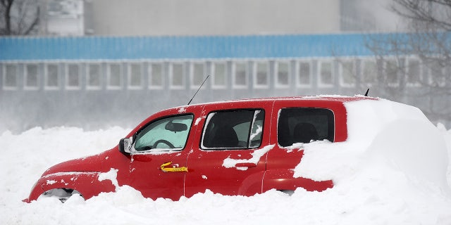  Ice and snow cover an abandoned vehicle along the Lake Erie shoreline on December 24, 2022, in Hamburg, New York. 