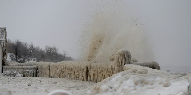 Ice and snow covering railings along the shoreline of Lake Erie in Hamburg, New York, December 24, 2022.