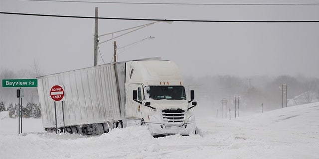A truck remains stuck in snow along the Lake Erie shoreline on December 24, 2022, in Hamburg, New York.