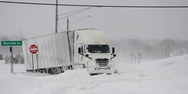 A truck remains stuck in snow along the Lake Erie shoreline on December 24, 2022 in Hamburg, New York.