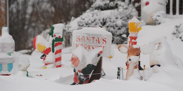 Christmas decorations are covered in snow on December 24, 2022 in Hamburg, New York.