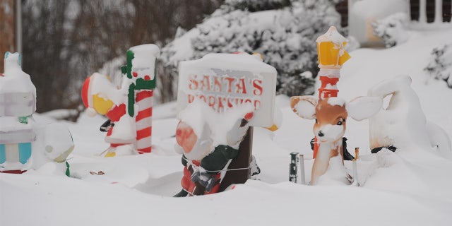 Christmas decorations are covered in snow on December 24, 2022 in Hamburg, New York.