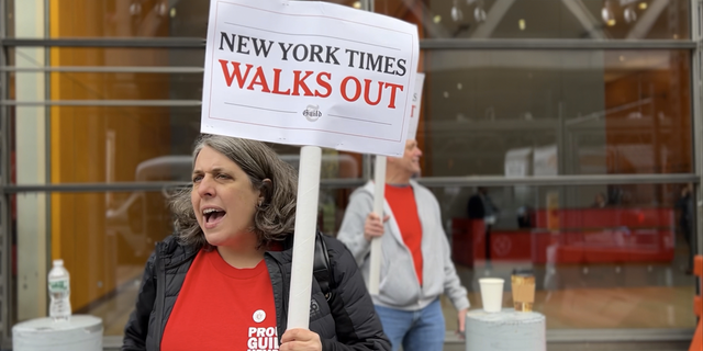 A New York Times staffer pickets in Manhattan on Thursday.