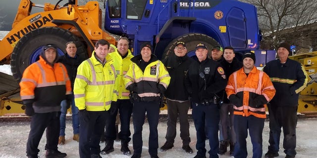 Erie County Executive Mark Poloncarz stands with members of a Nassau County crew who was sent to assist with cleanup and recovery efforts after a blizzard struck Northwest New York