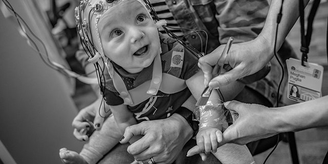 University of Virginia neuroscientists record the brain activity of nine-month-old Ian Boardman while brushing his skin to activate nerve fiber responses.