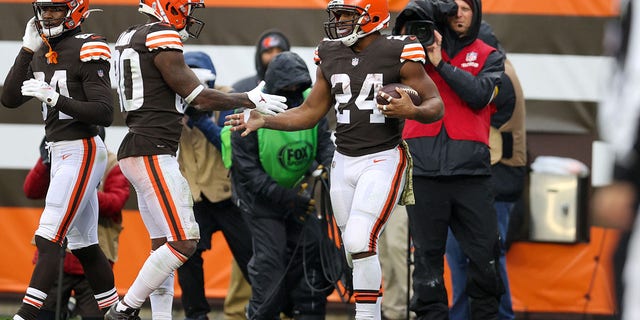 Cleveland Browns running back Nick Chubb (24) is congratulated by wide receiver Jarvis Landry (80) after scoring a touchdown during the second quarter of a game against the Detroit Lions Nov. 21, 2021, at FirstEnergy Stadium in Cleveland. 