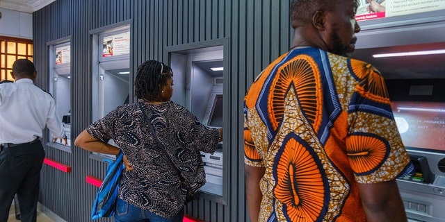 FILE: Customers use automatic teller machines (ATMs) at a United Bank of Africa Plc (UBA) branch in Lagos, Nigeria on Tuesday, Nov. 22, 2022. 