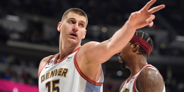 Denver Nuggets center Nikola Jokic gestures after being called for a foul in the second half of an NBA basketball game against the Charlotte Hornets, Sunday, Dec. 18, 2022, in Denver.