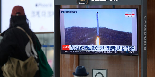 A television screen shows a picture of North Korea's rocket with test satellite during a news program at Seoul Railway Station in Seoul, South Korea on Saturday, Dec. 31, 2022. The North fired another missile a few hours earlier of South Korean and Japanese leaders were due to meet on Thursday. 