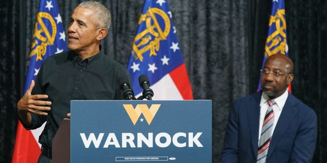 Former President Obama, left, speaks during a campaign rally for Senator Raphael Warnock, a Democrat from Georgia, in Atlanta, Georgia, on Thursday, Dec. 1, 2022. Obama returned to Georgia to campaign for Warnock in the closing days of the runoff election with Republican Herschel Walker.