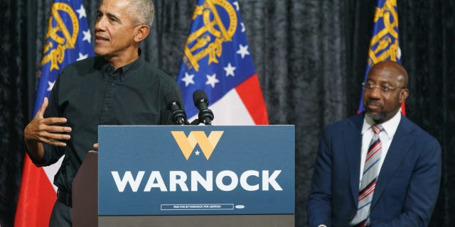 Former President Barack Obama, left, speaks during a campaign rally for Senator Raphael Warnock, a Democrat from Georgia, in Atlanta, Thursday, Dec. 1, 2022.