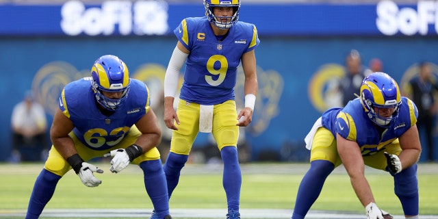Matthew Stafford #9 of the Los Angeles Rams sets up in the shotgun behind Brian Allen #55 and Oday Aboushi #63 during a 31-14 loss to the San Francisco 49ers at SoFi Stadium on October 30, 2022 in Inglewood, California.