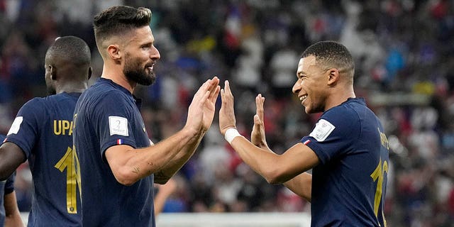 France's Olivier Giroud, left, and Kylian Mbappe celebrate after scoring against Poland, at the Al Thumama Stadium in Doha, Qatar, Sunday, Dec. 4, 2022.