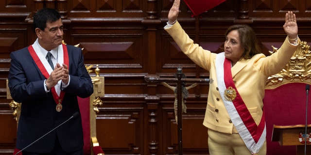 Dina Boluarte, right, greets members of the Peruvian Congress after being sworn in as the new president hours after former President Pedro Castillo was impeached on Wednesday.