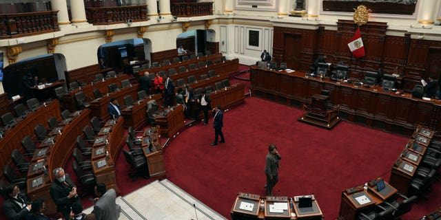 Lawmakers stand inside Congress on the day of their planned impeachment vote on President Pedro Castillo in Lima, Peru, Wednesday, Dec. 7, 2022. (AP Photo/Guadalupe Pardo)