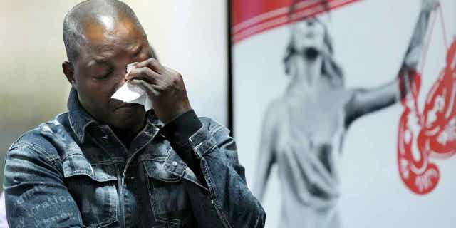 Peter Lyoya wipes his eyes after looking at a video of his son's shooting on Dec. 7, 2022, in Detroit. The family of Patrick Lyoya, a Black motorist fatally shot by a white police officer, filed a lawsuit Wednesday in federal court against the former officer and the city of Grand Rapids.