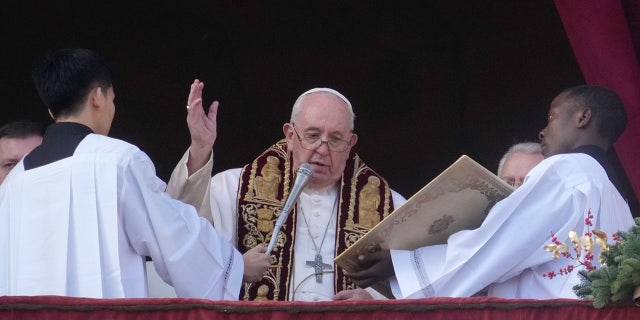 Pope Francis delivers the Christmas Day blessing from the main balcony of St. Peter's Basilica at the Vatican, Sunday, Dec. 25, 2022.