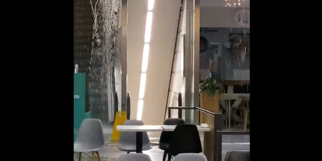 Water is seen coming out of the ceiling near an escalator inside the El Corte Ingles shopping mall in Lisbon, Portugal.