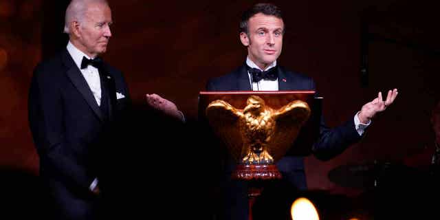 President Joe Biden listens as French President Emmanuel Macron speaks before a toast during a State Dinner on the South Lawn of the White House in Washington, Thursday, Dec. 1, 2022. (AP Photo/Andrew Harnik)