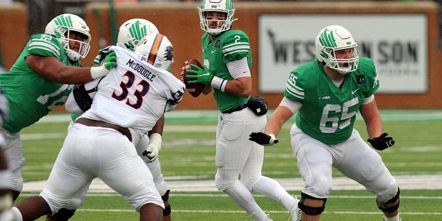 Austin Aune (2) of the North Texas Mean Green looks downfield for an open receiver against the UTSA Roadrunners at Apogee Stadium Nov. 27, 2021, in Denton, Texas.