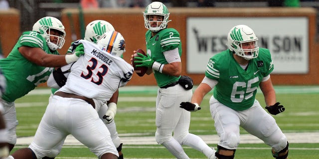 Austin Aune (2) of the North Texas Mean Green looks downfield for an open receiver against the UTSA Roadrunners at Apogee Stadium Nov. 27, 2021, in Denton, Texas.