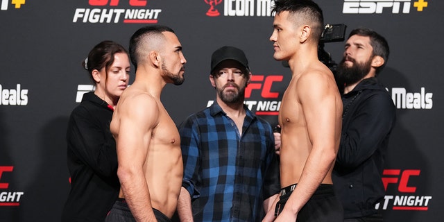 Rafa Garcia and Maheshate Hayisaer of China face off during the UFC Fight Night weigh-in at UFC APEX on December 16, 2022 in Las Vegas, Nevada.