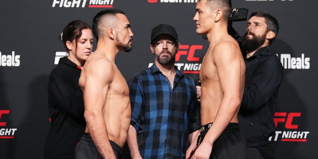 Rafa Garcia and Maheshate Hayisaer of China face off during the UFC Fight Night weigh-in at UFC APEX on December 16, 2022 in Las Vegas, Nevada.