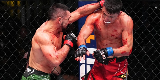 Rafa Garcia punches Maheshate of China in a lightweight fight during the UFC Fight Night event at UFC APEX on December 17, 2022 in Las Vegas, Nevada.