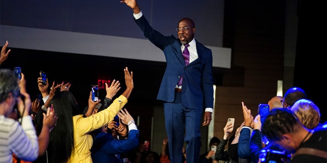 Sen. Raphael Warnock, D-Ga., arrives to his election night watch party on Tuesday in Atlanta.