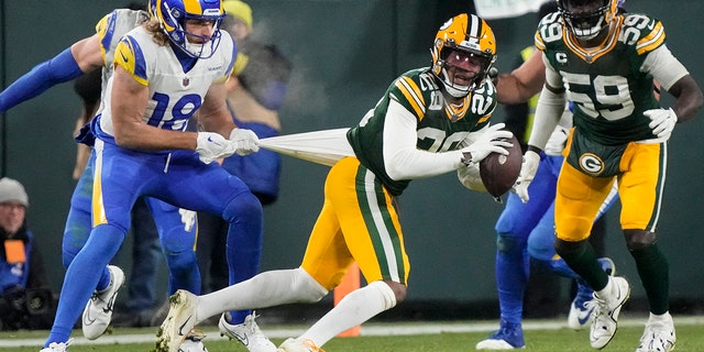 Los Angeles Rams wide receiver Ben Skowronek (18) tries to tackle Green Bay Packers cornerback Rasul Douglas (29) after an interception in the second half of an NFL football game in Green Bay, Wis. Monday, Dec. 19, 2022. 