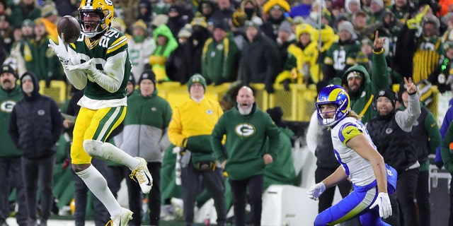 Rasul Douglas #29 of the Green Bay Packers intercepts a pass against the Los Angeles Rams at Lambeau Field on December 19, 2022 in Green Bay, Wisconsin.