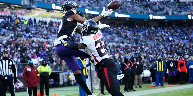 Baltimore Ravens wide receiver Demarcus Robinson (10) pulls in a touchdown reception over Atlanta Falcons cornerback Cornell Armstrong during the first half of an NFL football game, Saturday, Dec. 24, 2022, in Baltimore.