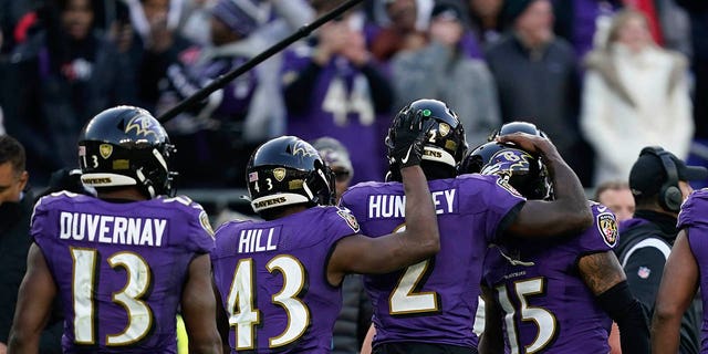 Baltimore Ravens players celebrate a touchdown by Baltimore Ravens quarterback Tyler Huntley, #2, in the final minute of an NFL football game against the Denver Broncos, Sunday, Dec. 4, 2022, in Baltimore.