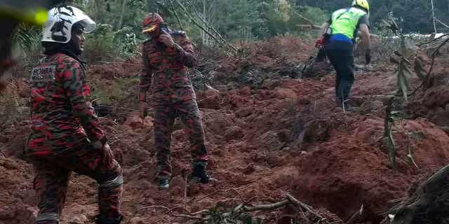 Rescuers work to find people's bodies buried under earth and debris following a landslide at a campsite in Batang Kali, Selangor state, on the outskirts of Kuala Lumpur, Malaysia on December 16, 2022. 