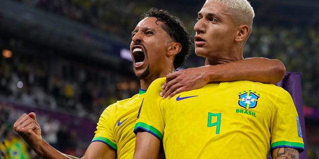 Brazil's Richarlison, right, celebrates after scoring his side's third goal with teammate Marquinhos during the World Cup Round of 16 match against South Korea, at the Education City Stadium in Al Rayyan, Qatar, Monday, Dec. 5, 2022.