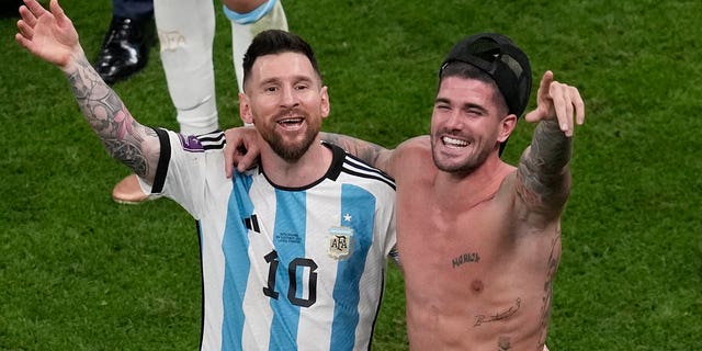 Argentina's Lionel Messi and Rodrigo De Paul, right, celebrate at the end of the World Cup quarterfinal soccer match between the Netherlands and Argentina, at the Lusail Stadium in Lusail, Qatar, Saturday, Dec. 10, 2022.