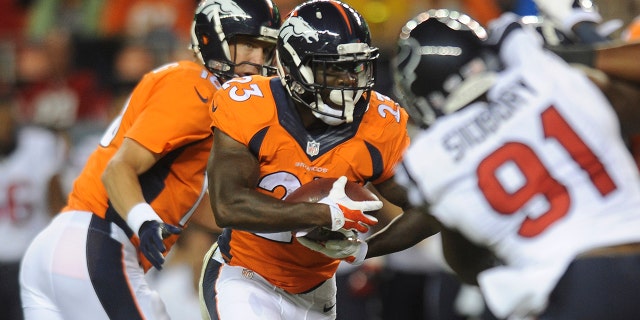 Denver Broncos running back Ronnie Hillman takes a handoff from Peyton Manning in the first quarter of a preseason football game against the Houston Texans at Sports Authority Field at Mile High on Saturday, August 23, 2014 in Denver, Colorado.