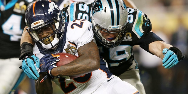 Ronnie Hillman, #23 of the Denver Broncos, is tackled by Luke Kuechly, #59 of the Carolina Panthers, in the third quarter during Super Bowl 50 at Levi's Stadium on Feb. 7, 2016 in Santa Clara, California.