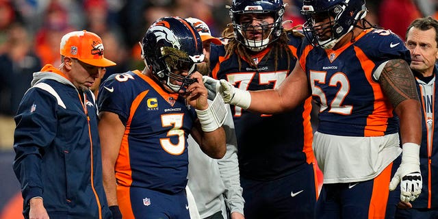 Broncos quarterback Russell Wilson is helped off the field during the Kansas City Chiefs game, Sunday, Dec. 11, 2022, in Denver.