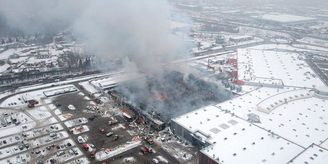 Smoke rises from the OBI mall in Khimki, just outside Moscow, Russia, on Dec. 9, 2022. A massive fire has destroyed a shopping mall on Moscow outskirts, killing one man.