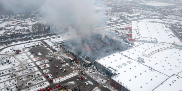 Smoke rises from the OBI mall in Khimki, just outside Moscow, Russia, on Dec. 9, 2022. A massive fire has destroyed a shopping mall on Moscow outskirts, killing one man.