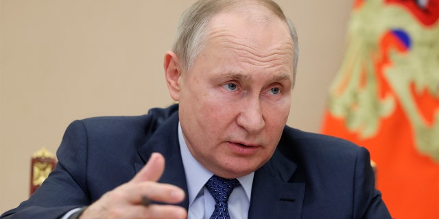 Russian President Vladimir Putin gestures as he speaks during the annual meeting of the Presidential Council for Civil Society and Human Rights by video conference in Moscow on Wednesday, December 7, 2022.